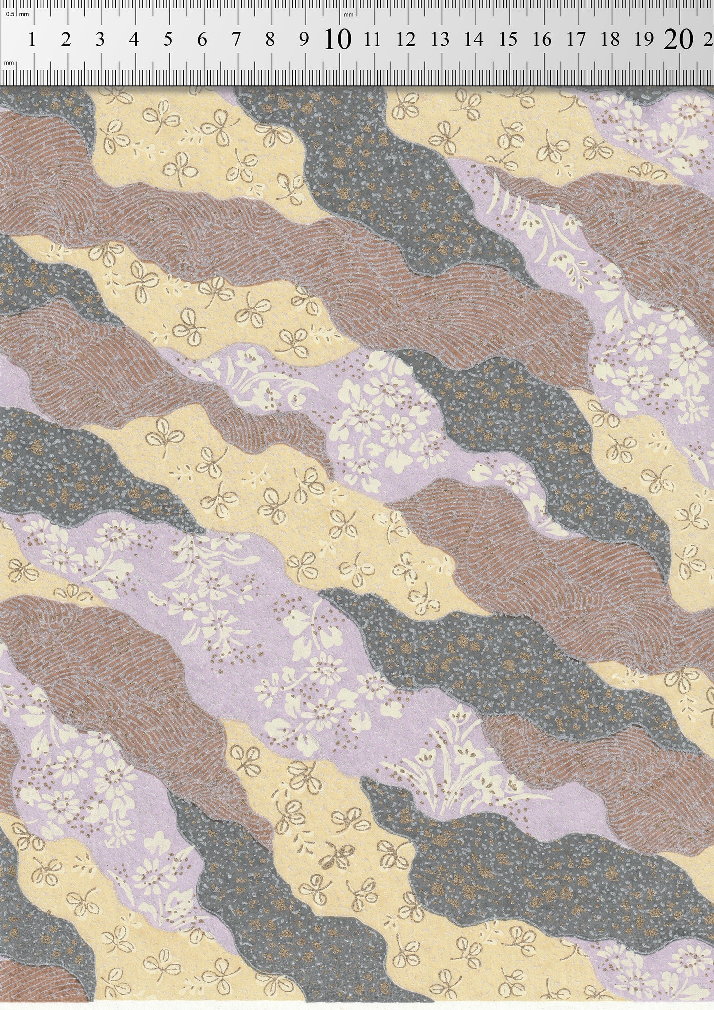Patterned chiyogami paper with wavy lines and floral designs on a measuring scale background