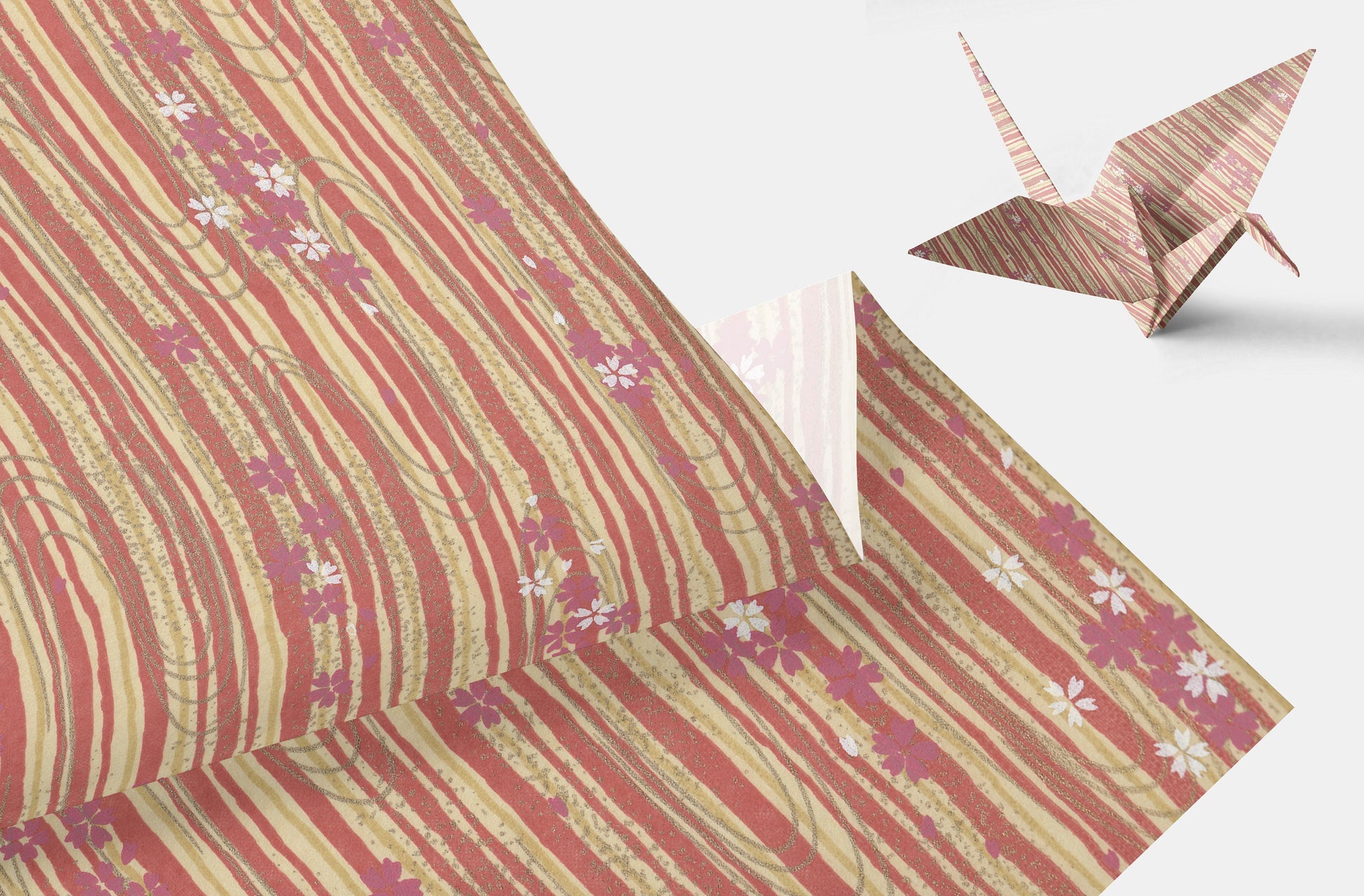 Chiyogami paper with floral pattern and origami crane on a white background