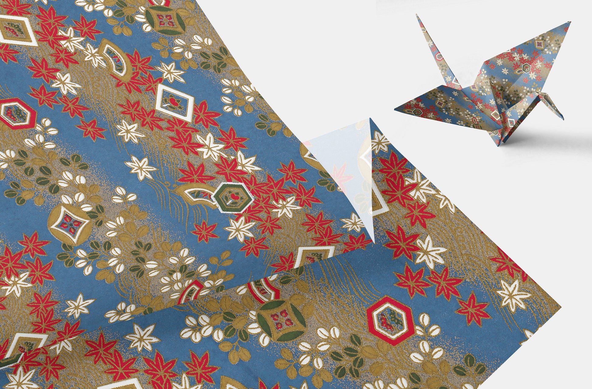 Decorative paper with geometric patterns and a folded paper crane on a white background