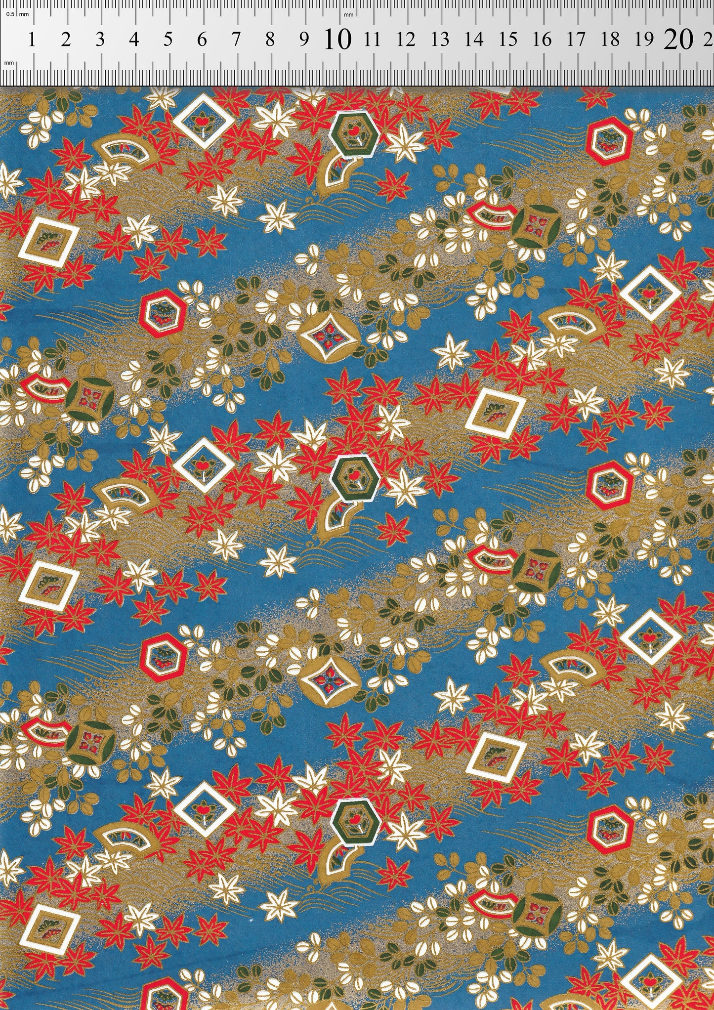 Festive chiyogami paper pattern with red, gold, and white elements on a blue background