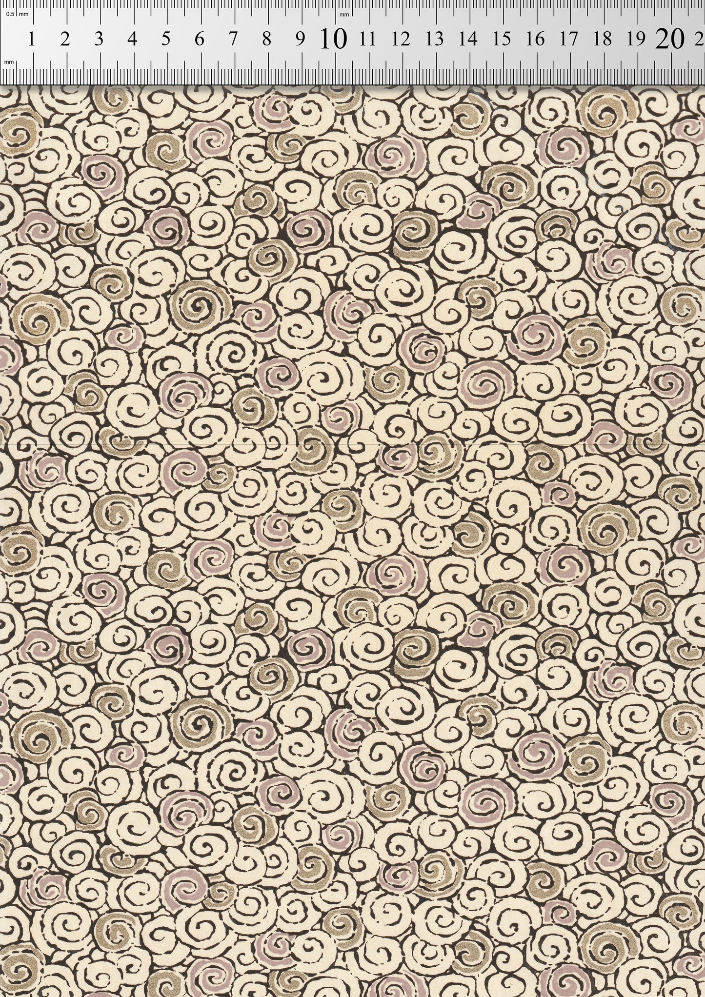 Patterned chiyogami paper with swirls in beige and brown on a neutral background