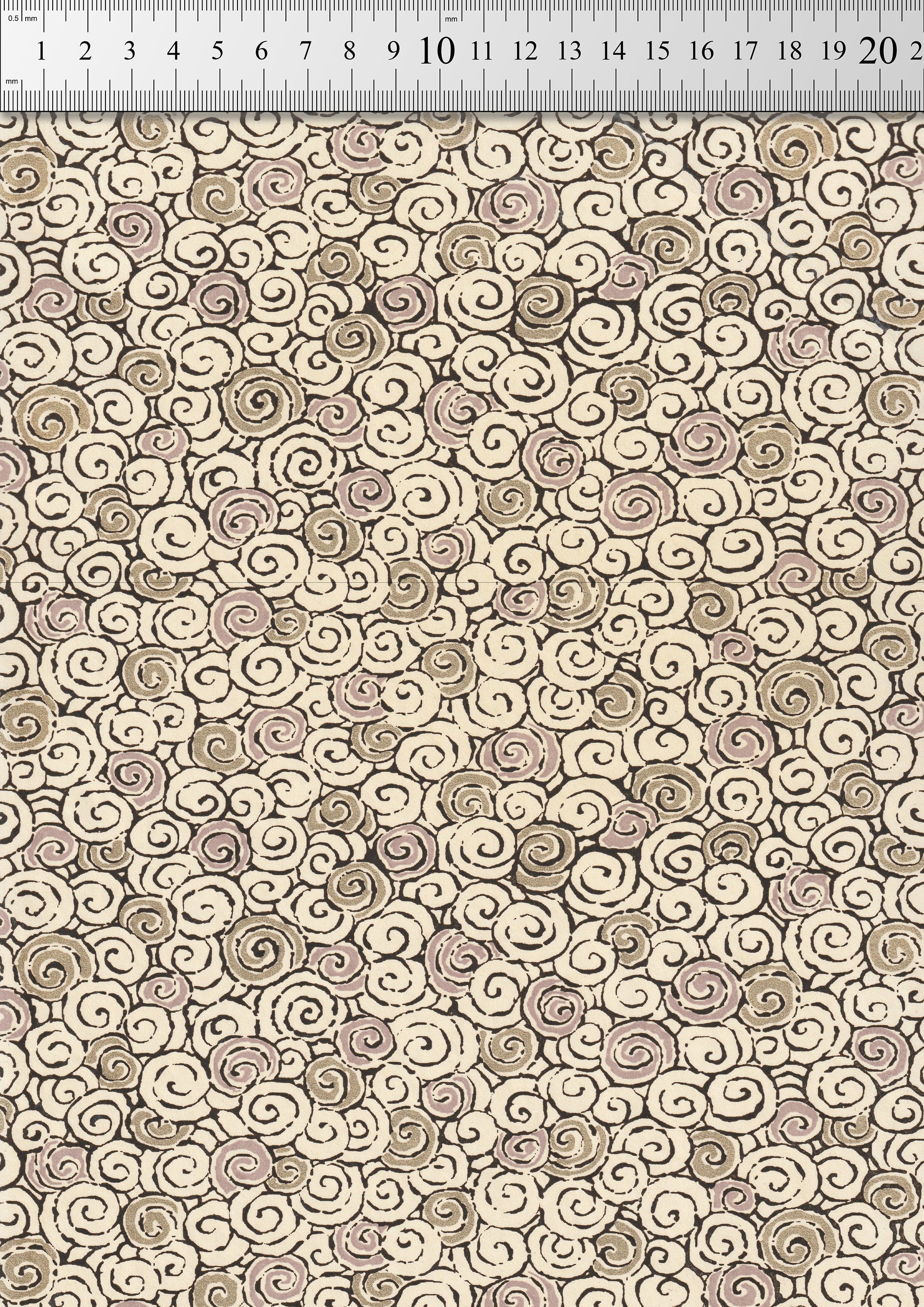 Patterned chiyogami paper with swirls in beige and brown on a neutral background