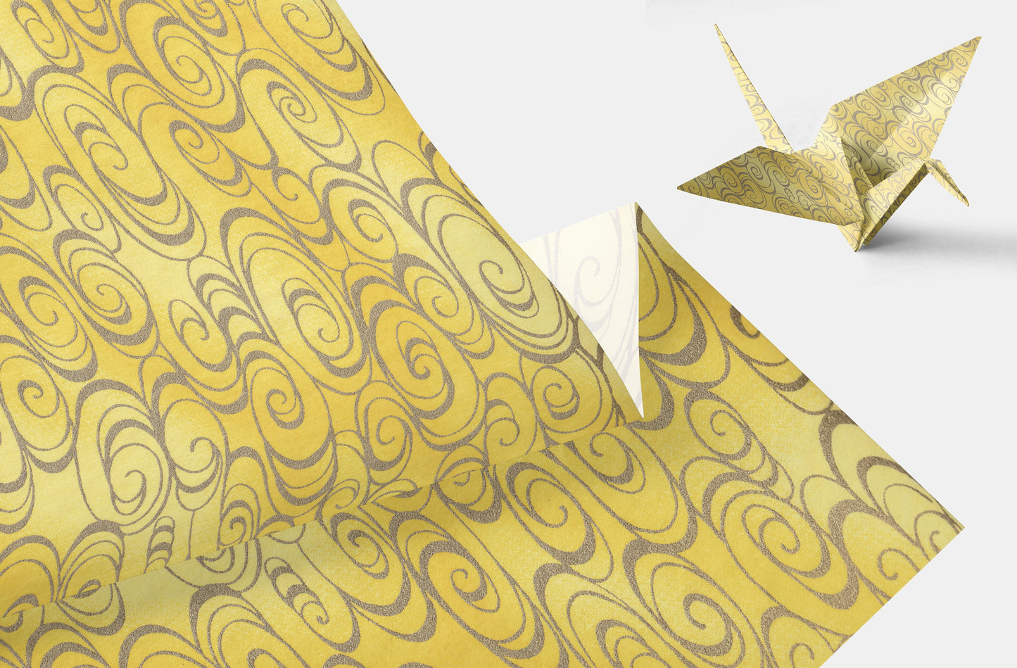 Chiyogami Paper with grey swirl patterns on yellow background featuring an origami crane.