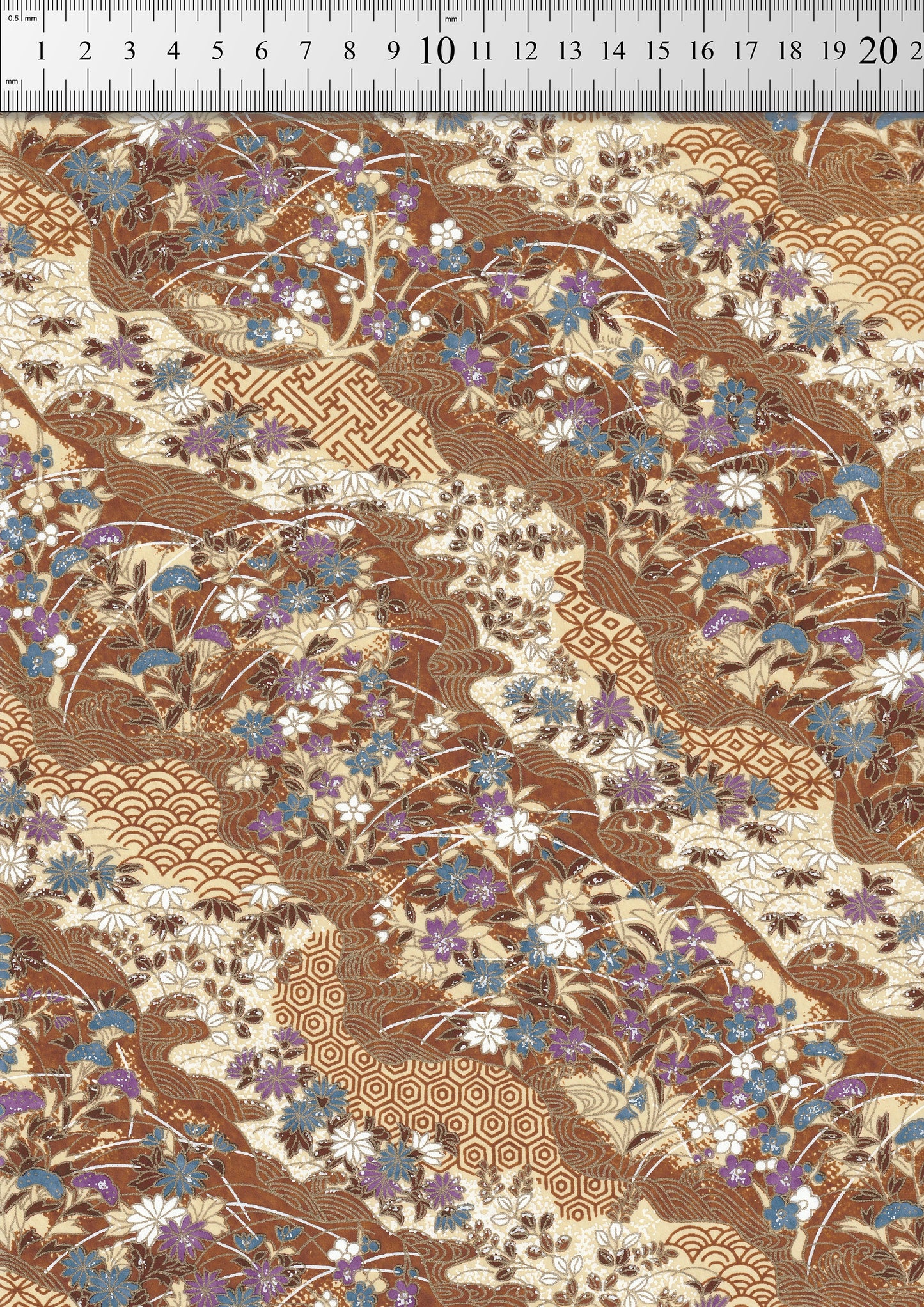 Floral and geometric patterned  chiyogami paper with a ruler at the top for scale.