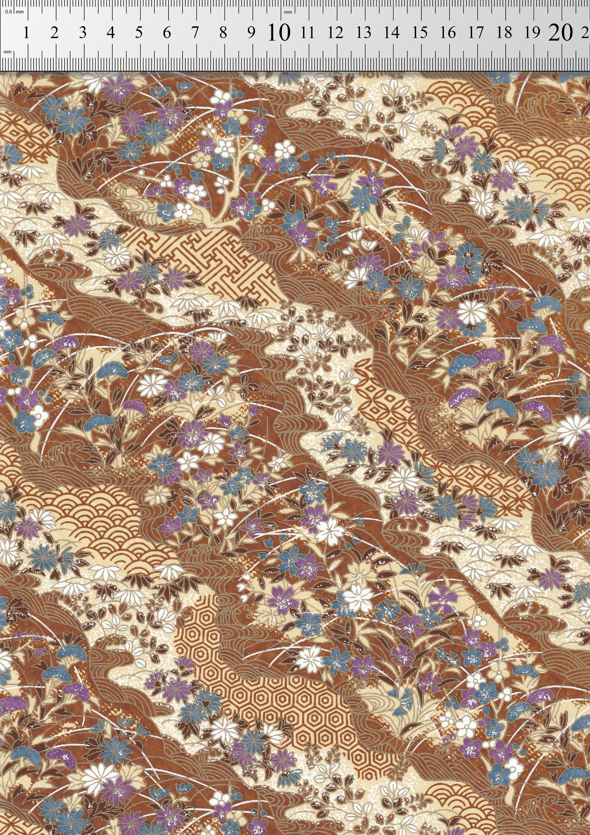 Floral and geometric patterned  chiyogami paper with a ruler at the top for scale.