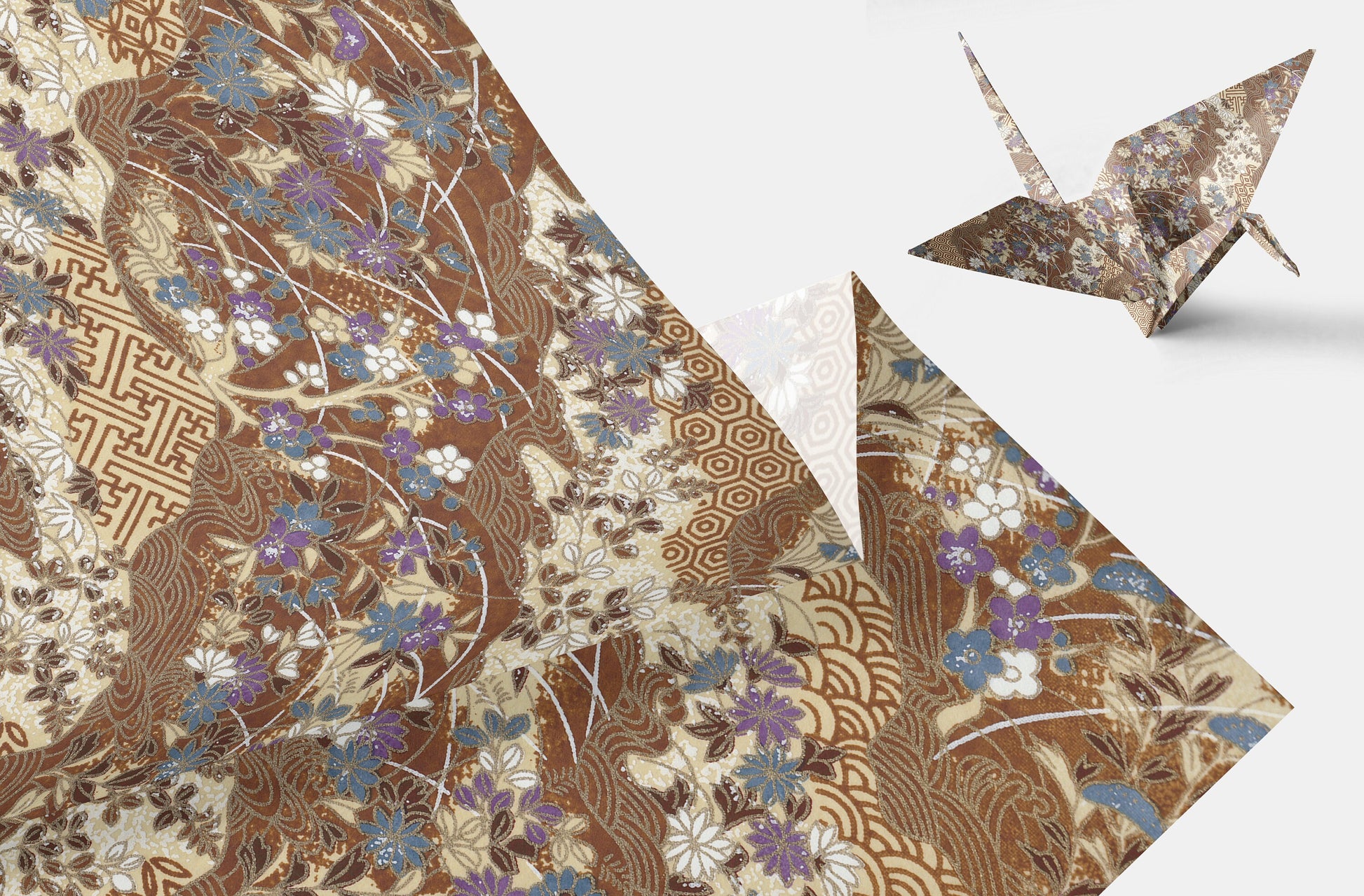 Decorative paper with intricate patterns and a folded paper crane on a white background