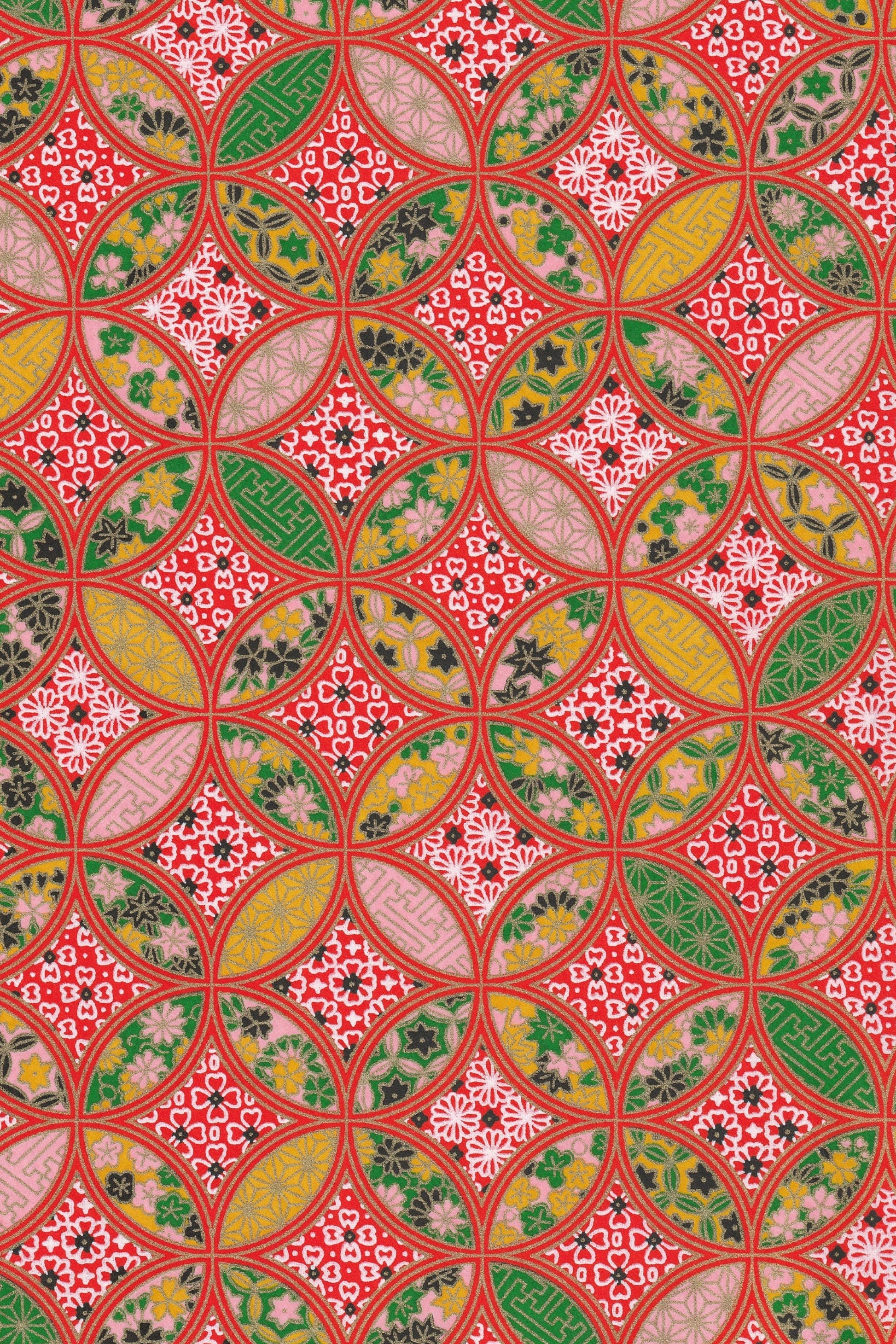 Decorative chiyogami paper with a geometric pattern in red, green, and yellow.