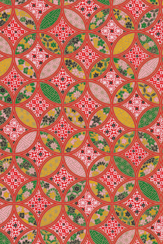 Decorative chiyogami paper with a geometric pattern in red, green, and yellow.