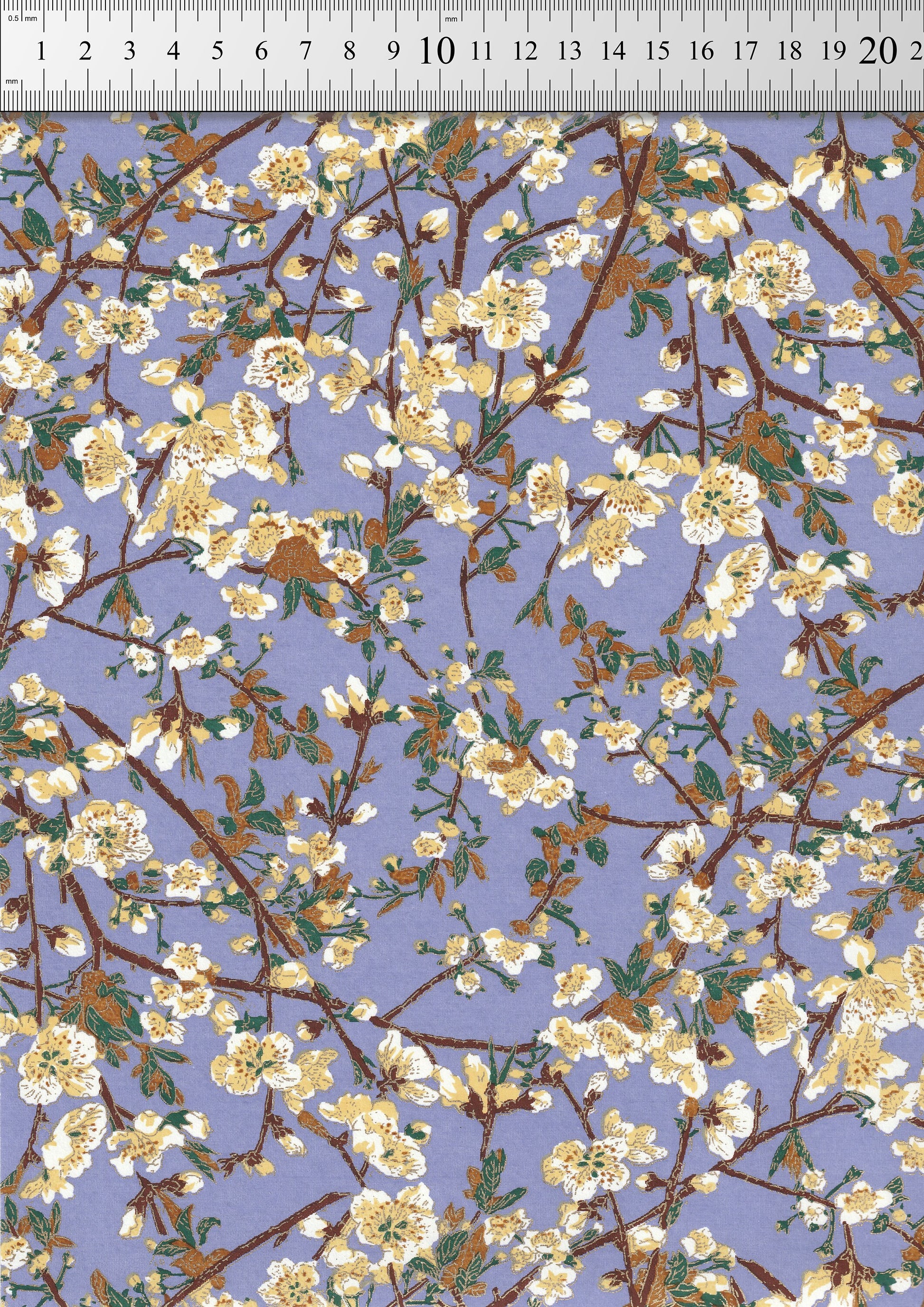 Floral pattern chiyogami paper with white flowers on a blue background with a ruler for scale