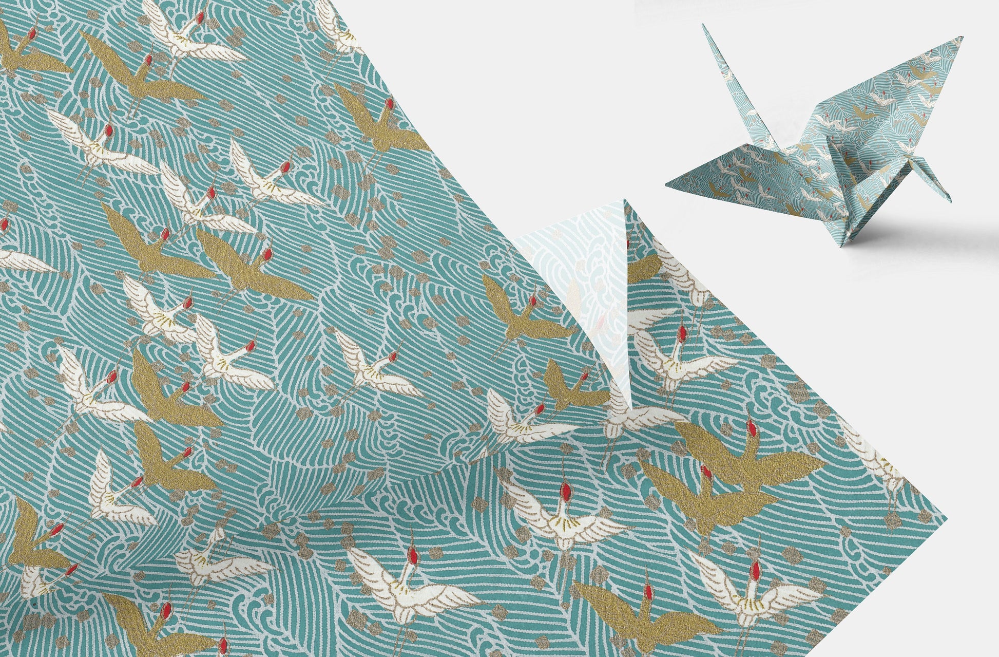 Chiyogami paper with Pattern of white and gold cranes on a teal background and a folded paper crane on a white background