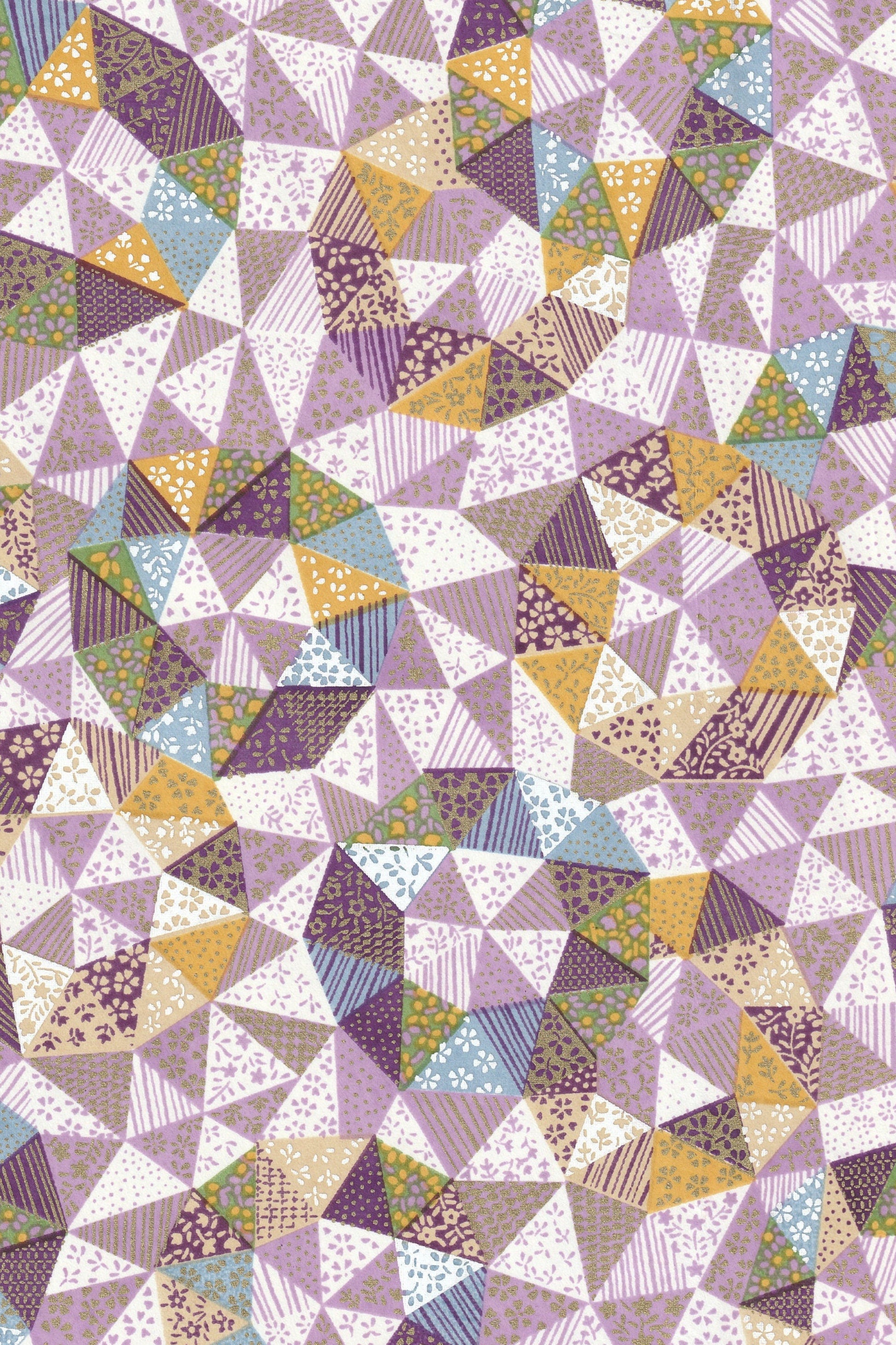 Patterned chiyogami paper with a mix of triangles in various colors on a white background