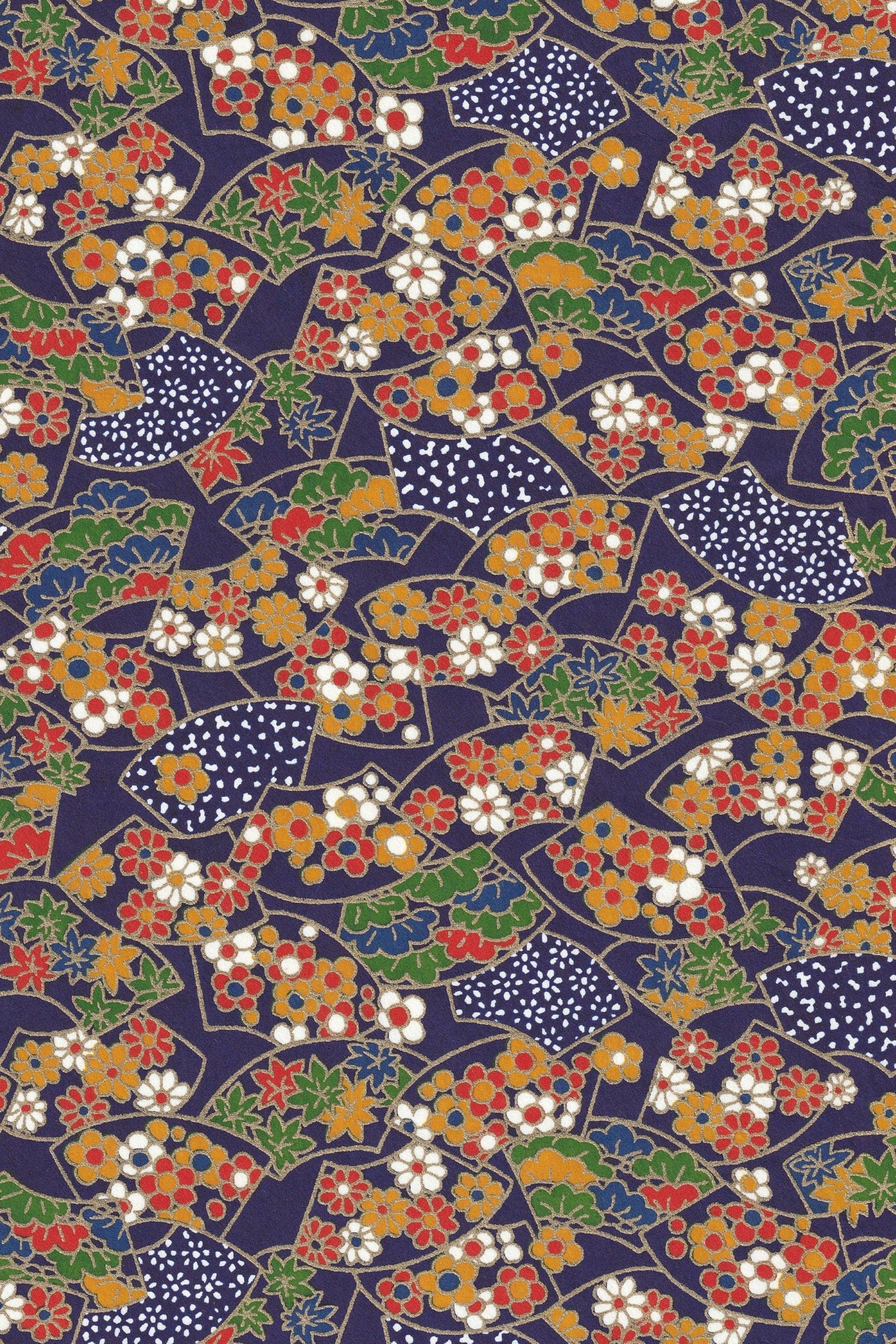 Chiyogami paper with colorful pattern of fans and flowers on a dark blue background