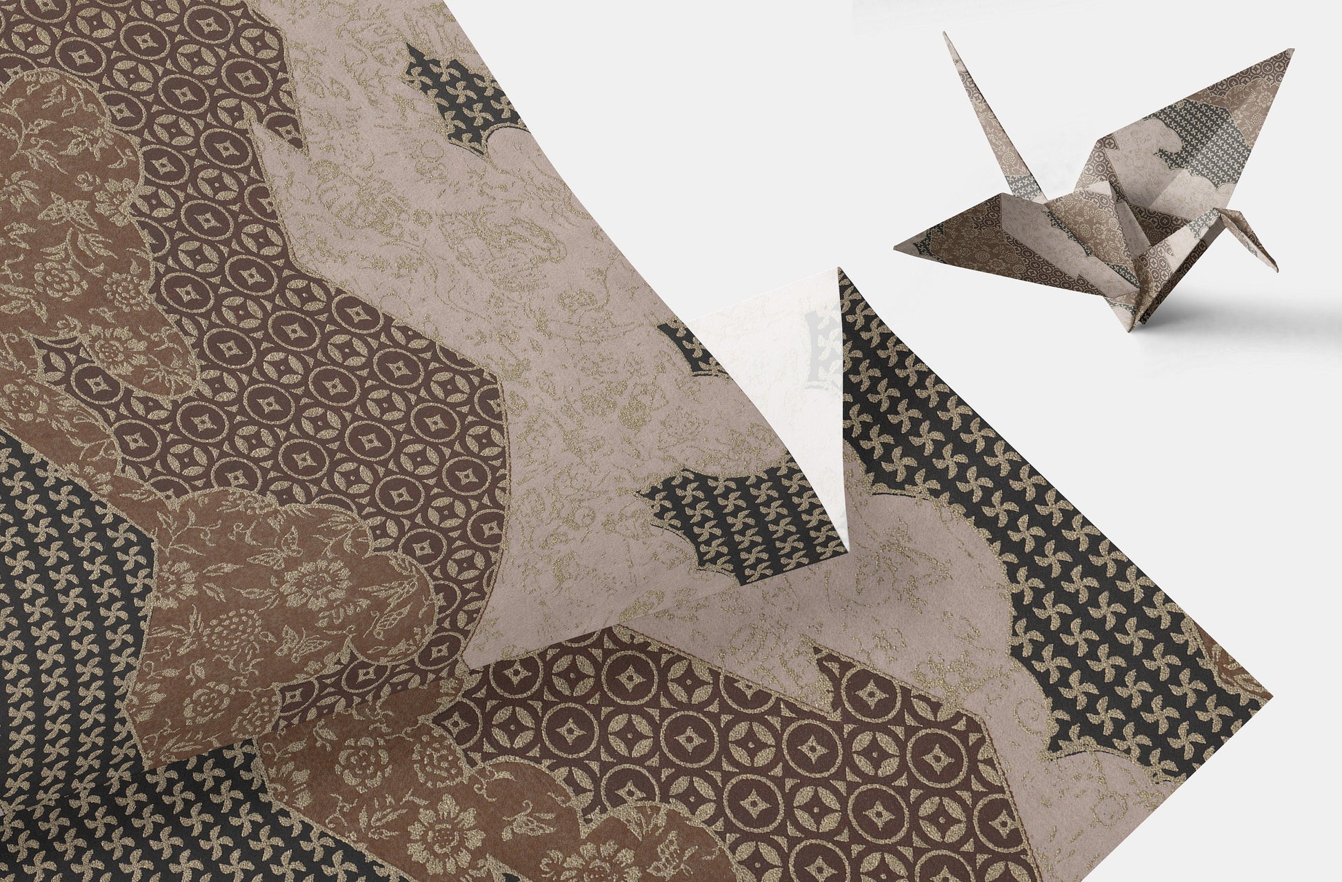 Textile with intricate patterns and a paper crane on a white background