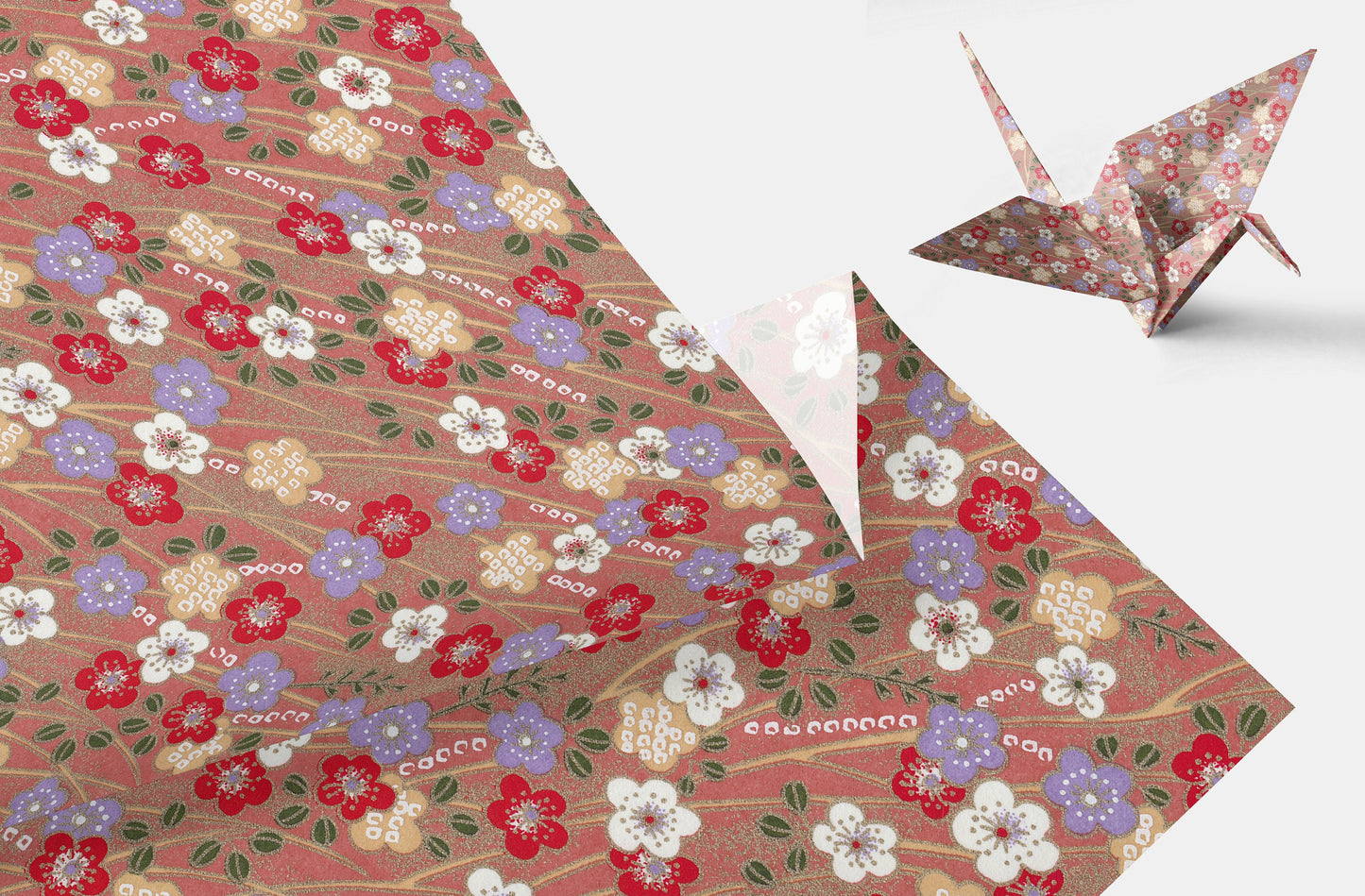 Floral-patterned chiyogami paper with a folded paper crane on a white background