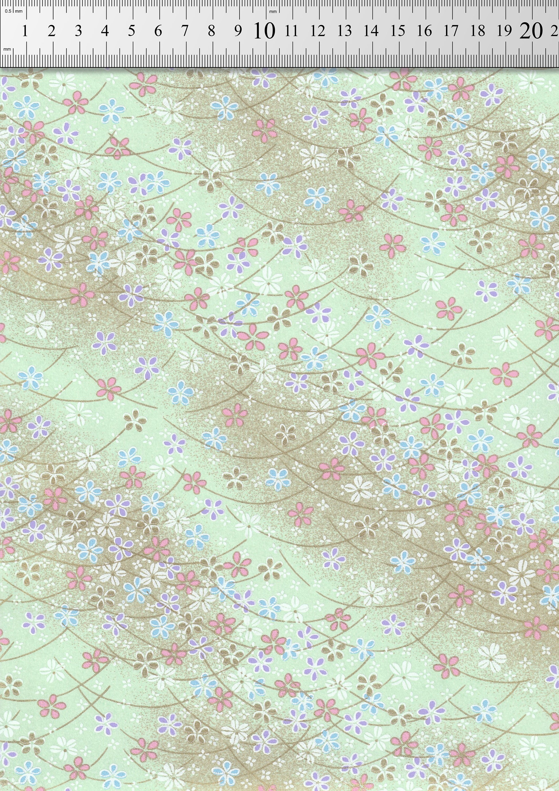 Floral patterned  chiyogami paper with a ruler at the top for scale.