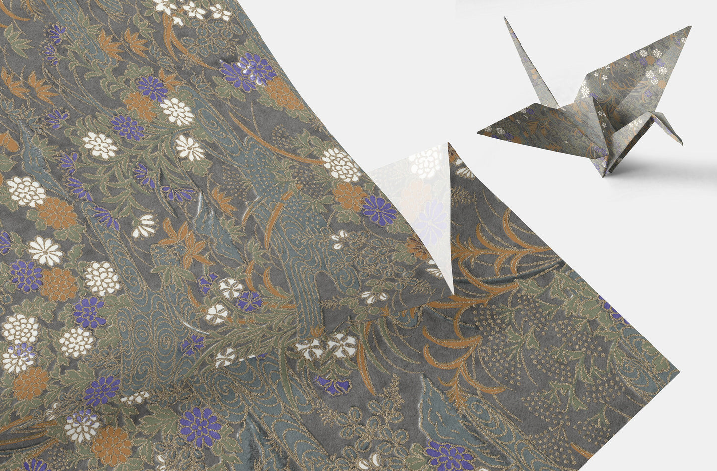Decorative chiyogami paper with floral pattern and a folded origami crane on a white background