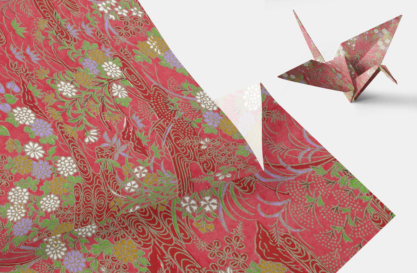 Decorative chiyogami paper with floral patterns and an origami crane on a white background