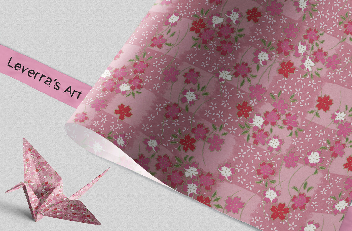 Floral-patterned chiyogami paper with an origami crane and a pink banner displaying 'Leverra's Art'.