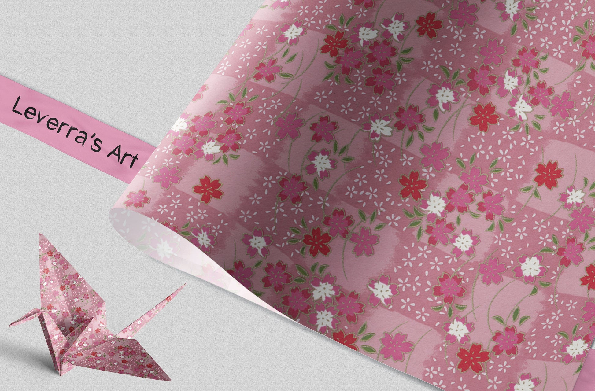 Floral-patterned chiyogami paper with an origami crane and a pink banner displaying 'Leverra's Art'.