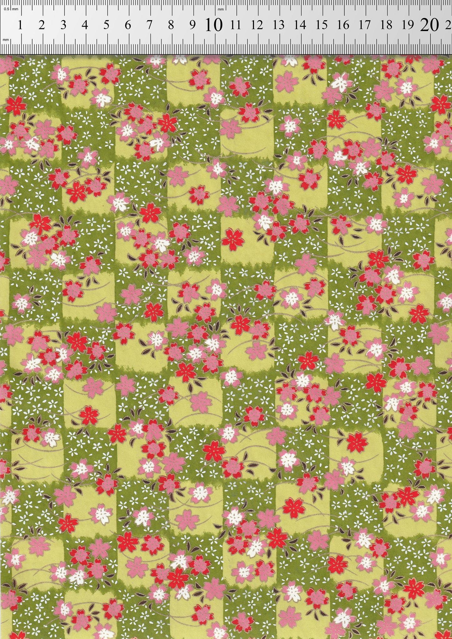 Floral patterned  chiyogami paper with red and pink flowers on a green background