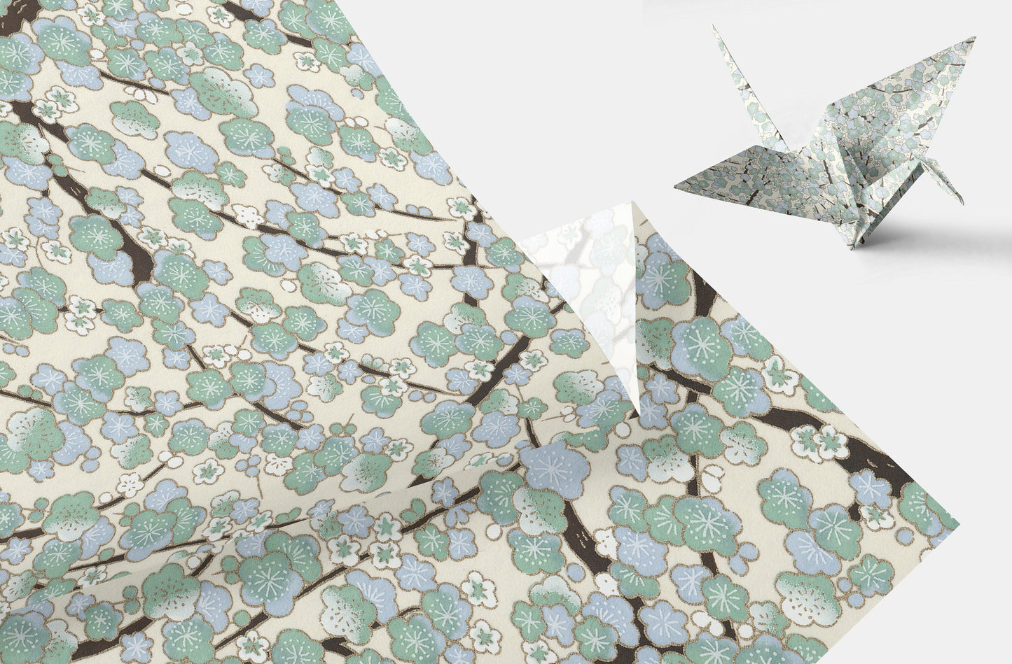 Floral-patterned chiyogami paper with a folded paper crane on a white background
