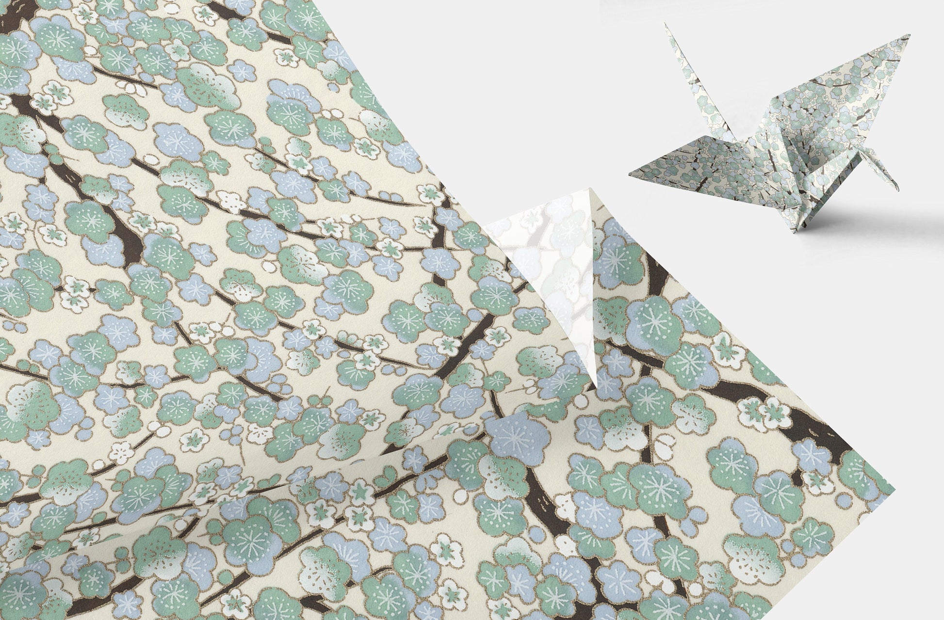 Floral-patterned chiyogami paper with a folded paper crane on a white background
