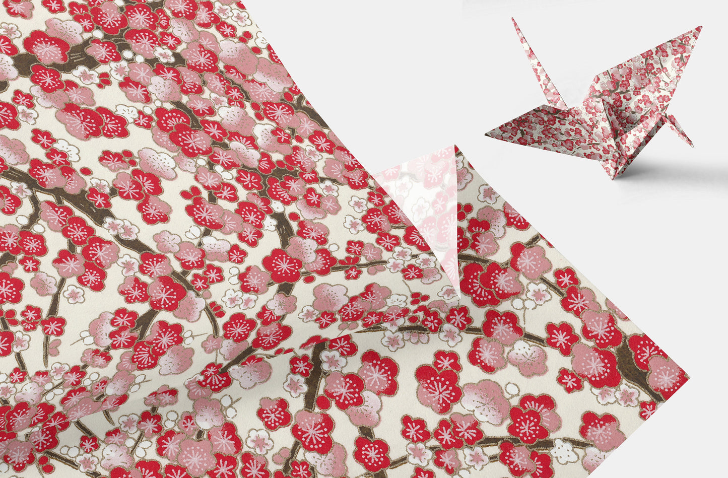 Floral patterned chiyogami paper with a folded paper crane on a white background