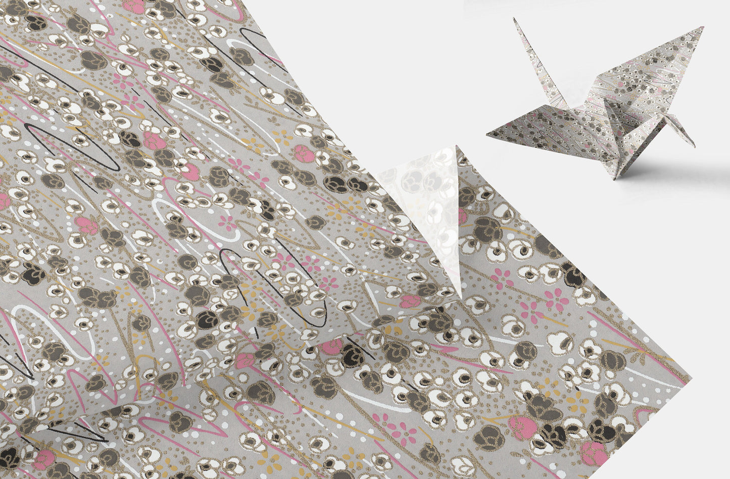 Decorative paper with floral pattern and a folded paper crane on a white background