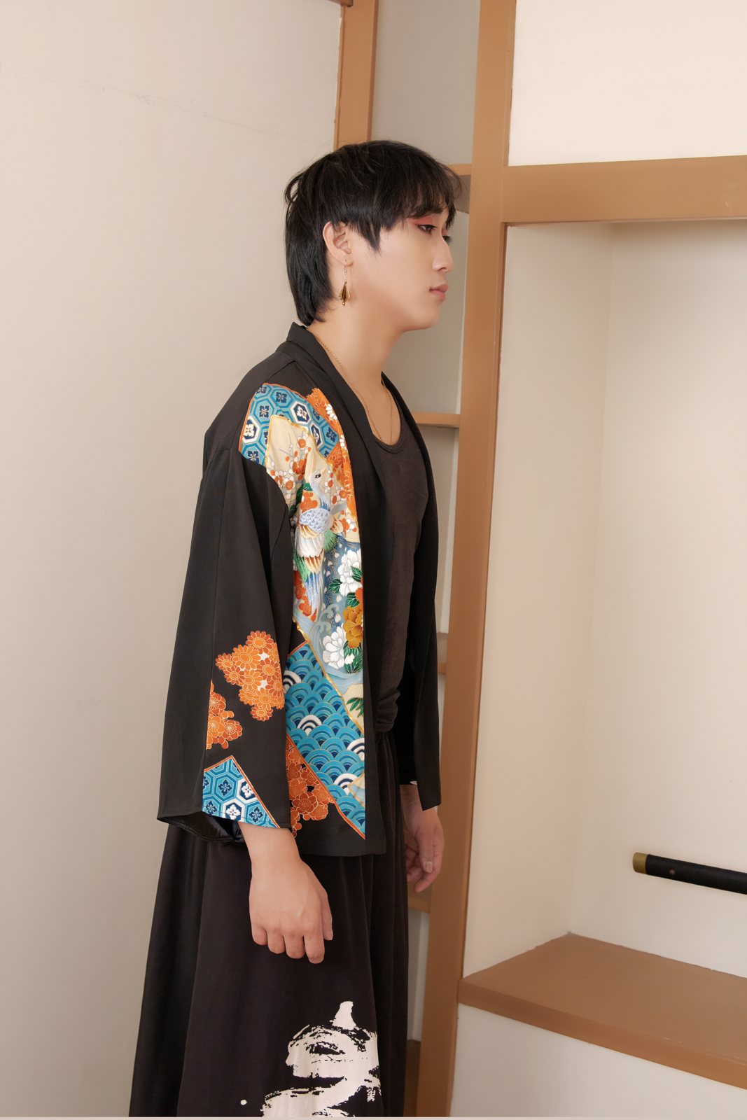 Man wearing a black upcycled kimono jacket with colourful pattern by Leverras Art